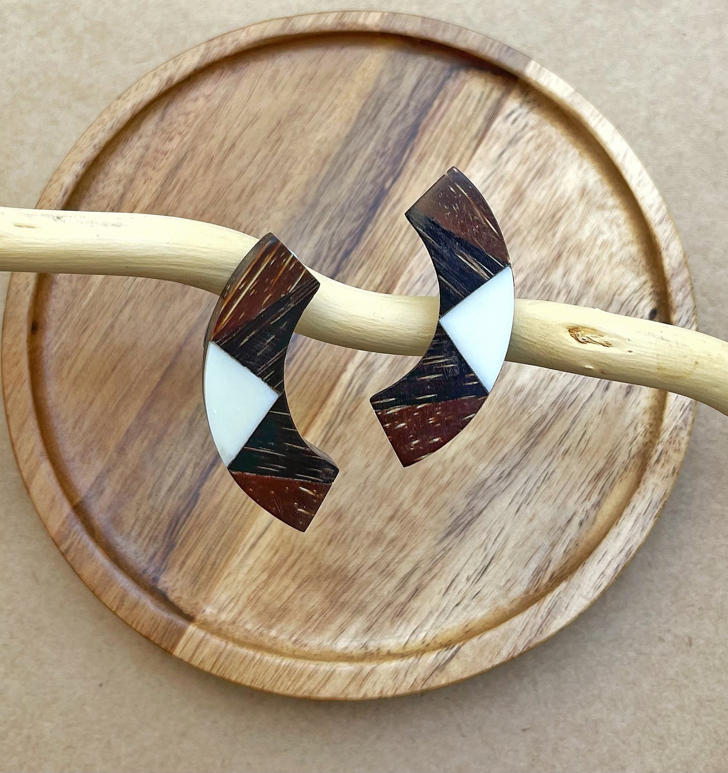 Handcrafted earrings! Triangular bone marquetry on a wooden stand creates geometric beauty.