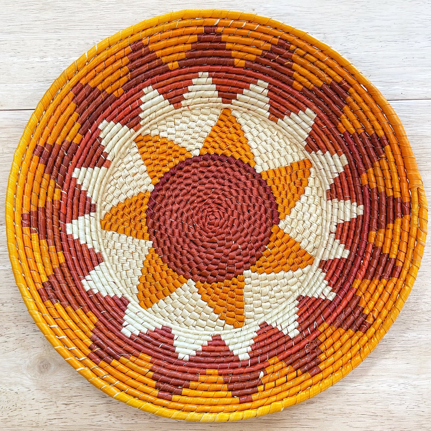 Round, handwoven bowls crafted from natural tucumã straw. Golden or brown, smooth or textured finish based on weave. Flat bottom, tapers slightly.