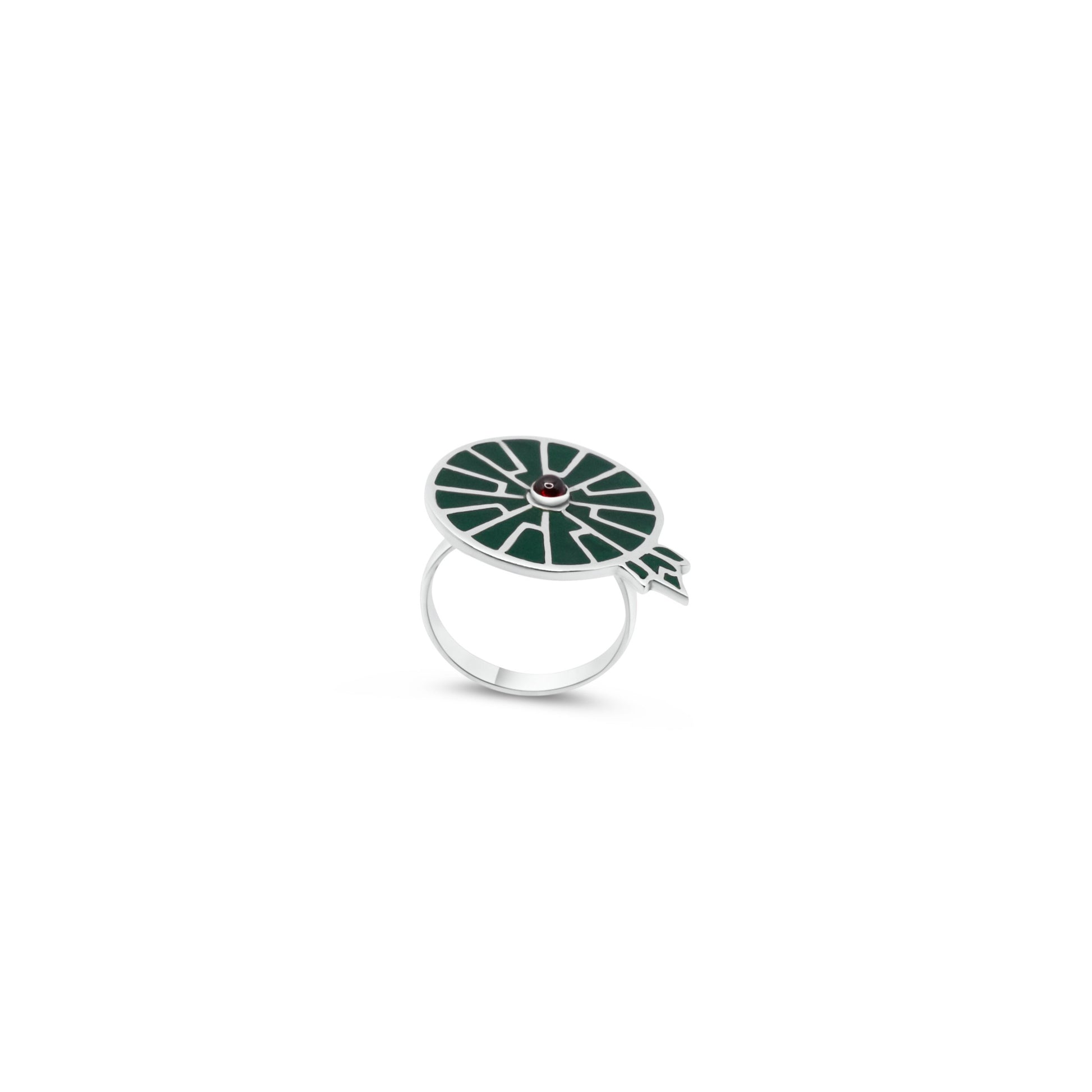 Sterling silver ring inspired by the Victoria Amazonica, with a green inlay and a garnet center, symbolizing the lushness of the Amazon.