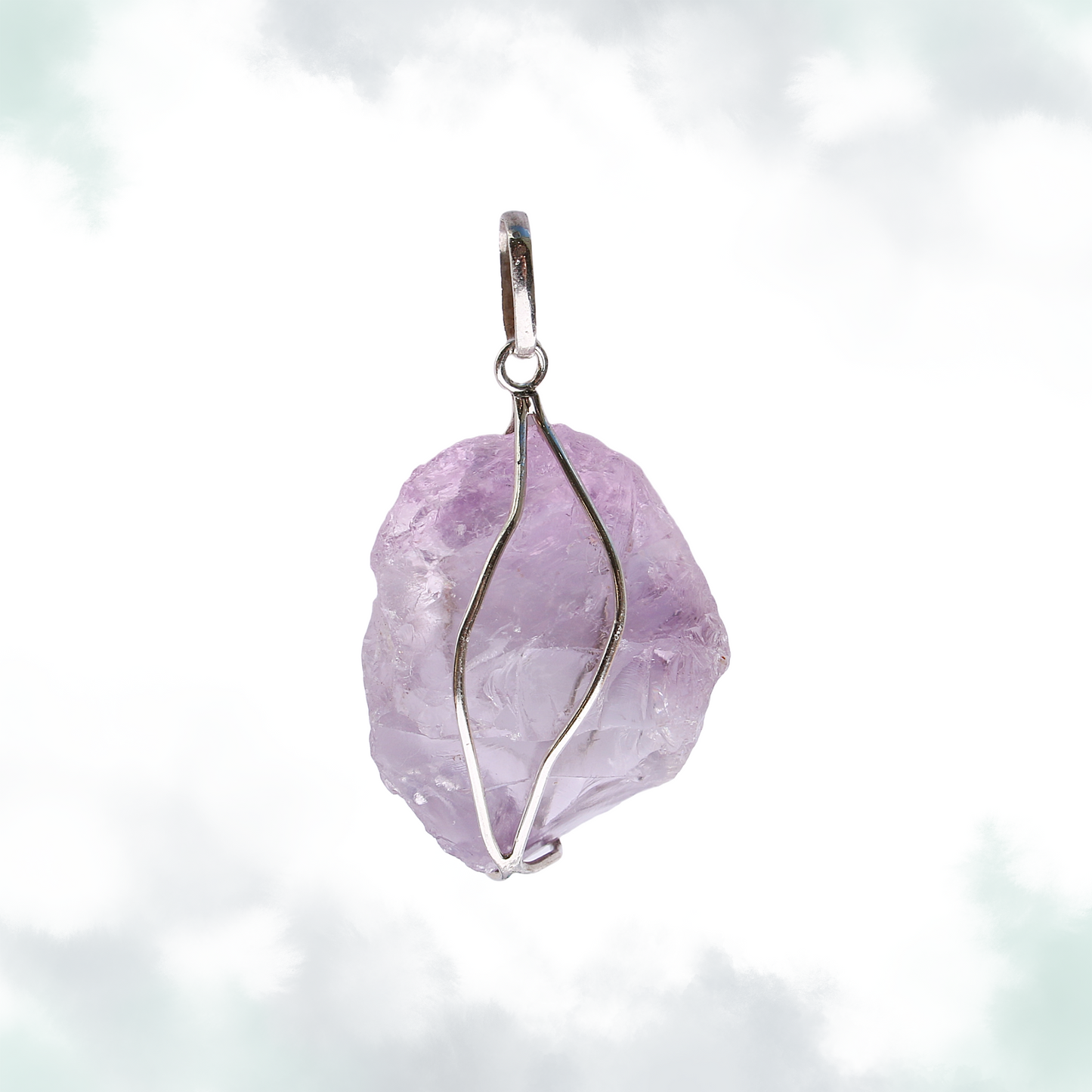 Raw amethyst pendant with a simple silver wire wrap, set against a soft, cloud-like background.