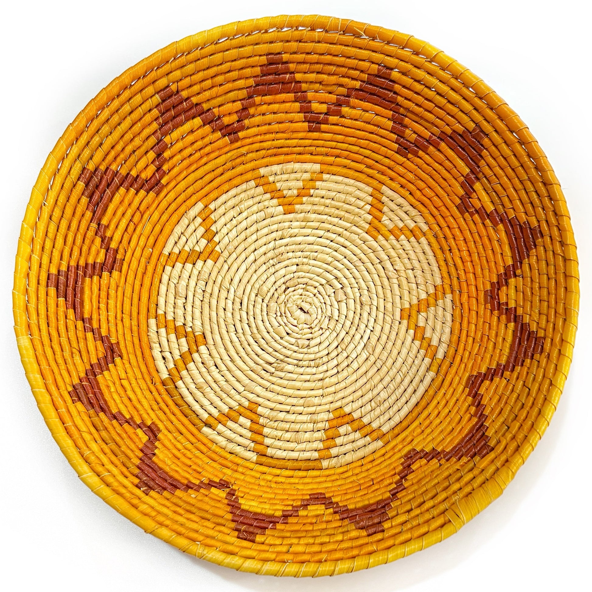 Handwoven Tucuma palm bowl with a swirling pattern in natural and earthy tones, epitomizing Amazonian artisanal skill