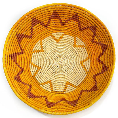 Handwoven Tucuma palm bowl with a swirling pattern in natural and earthy tones, epitomizing Amazonian artisanal skill