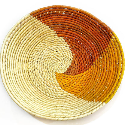 Artisanal Tucuma palm bowl with a cream base, featuring a gradient spiral of warm amber to rich browns, reflecting Amazonian heritage