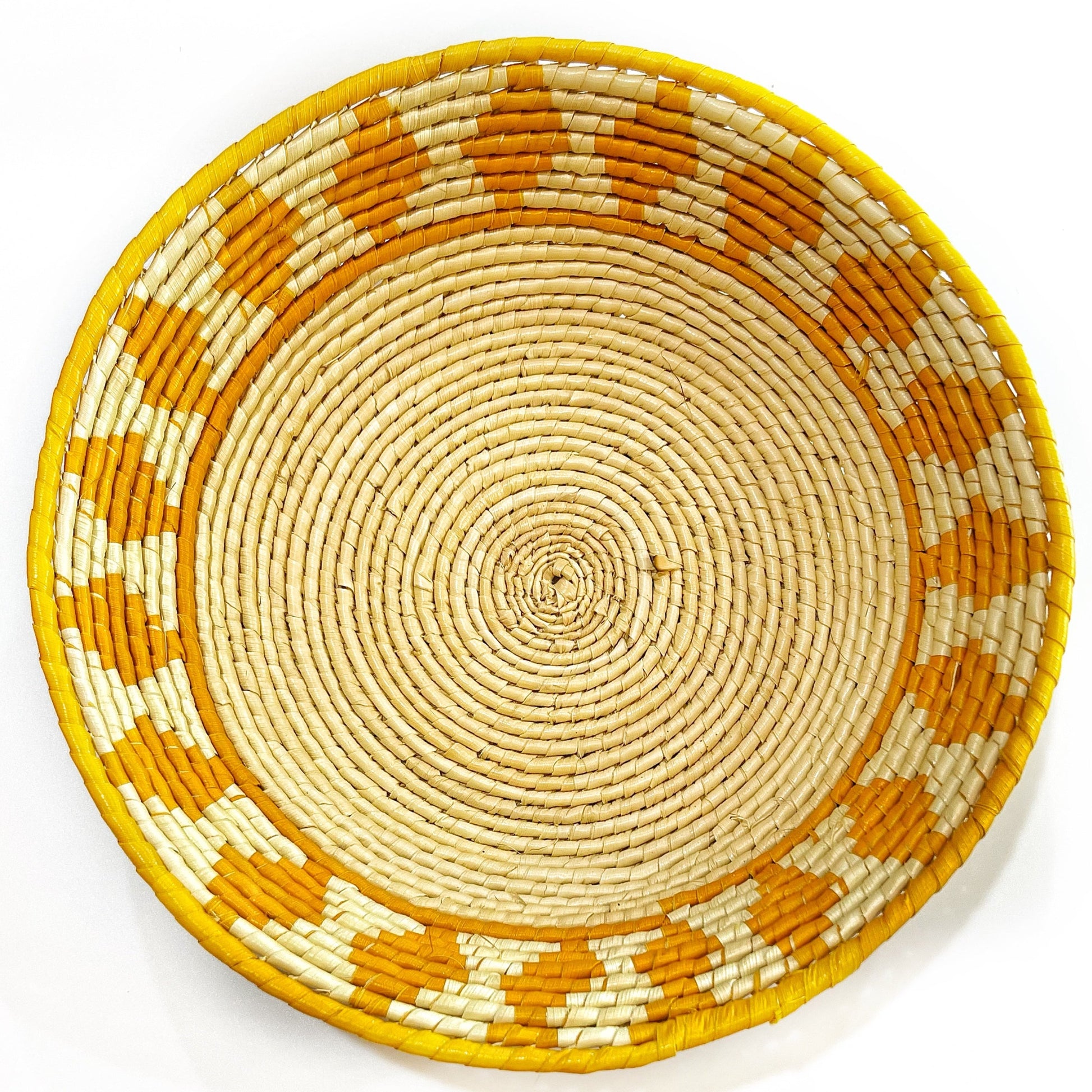 A handcrafted bowl from Amazon's tucuma palm, featuring a cream base with orange accents and a bold rim, showcasing traditional weaving.