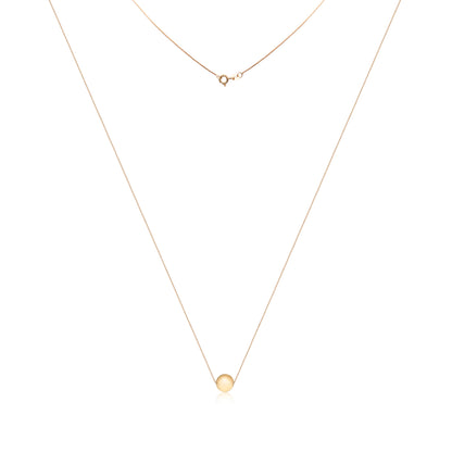 An 18k gold necklace with a smooth, circular pendant, exuding simplicity and elegance, symbolizing eternal unity.