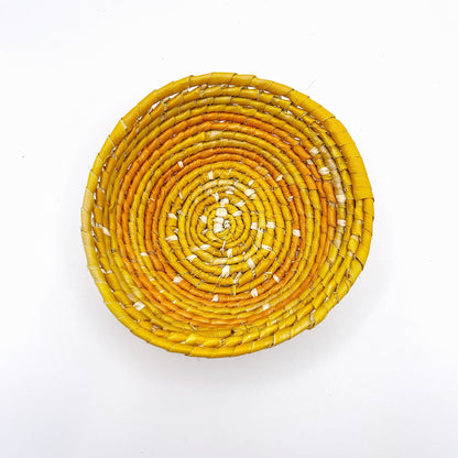 This bowl shows a vibrant array of colors in a spiraled design, with a natural beige at the center transitioning to bands of yellow and deepening to a rich orange at the rim.