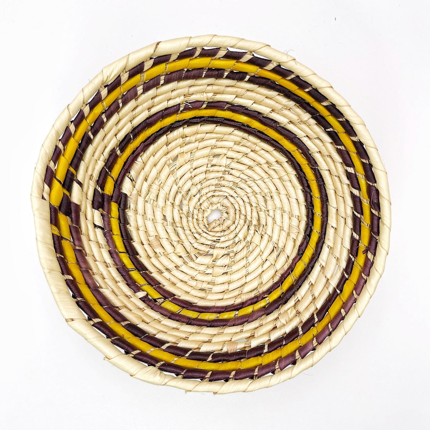  The bowl features concentric circles in beige, accented with bands of purple, and yellow, showcasing the intricate handwoven pattern.