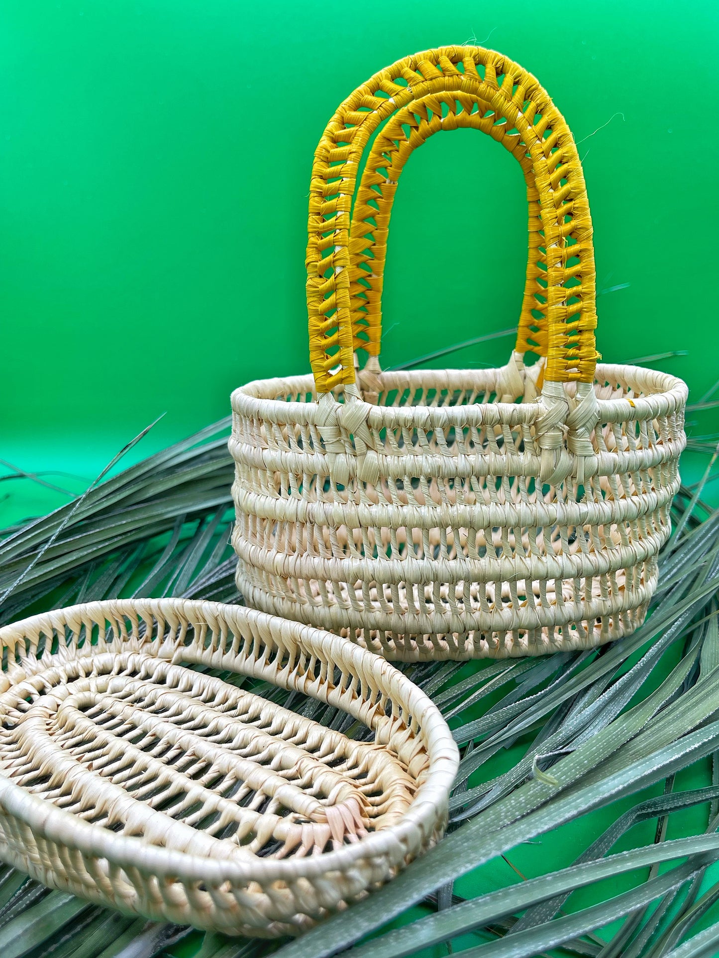 Mini handwoven Amazonian basket with lid. Natural beige tucuma fiber, accented with vibrant yellow wrapping on handle and lid edge. Tight spiral weave, approximately 5" long.