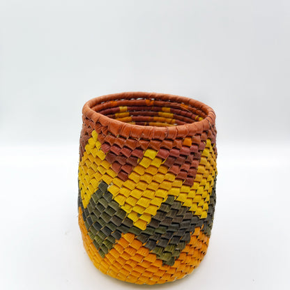 Woven holder with a diamond pattern in yellow, green, and brown, showcasing intricate handiwork.