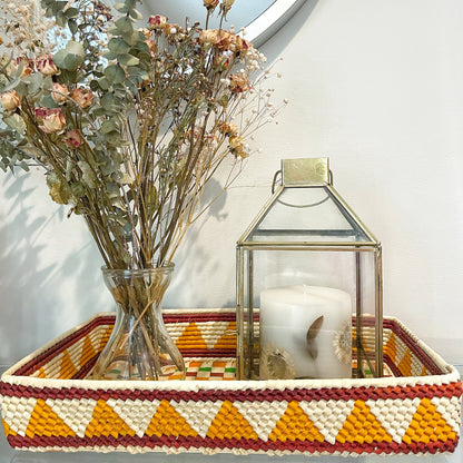 Handwoven Amazonian tray: Creamy white, mustard yellow, rust orange & brown in geometric pattern. Diamonds & triangles add texture. Functional & decorative, brings warmth with natural fibers.