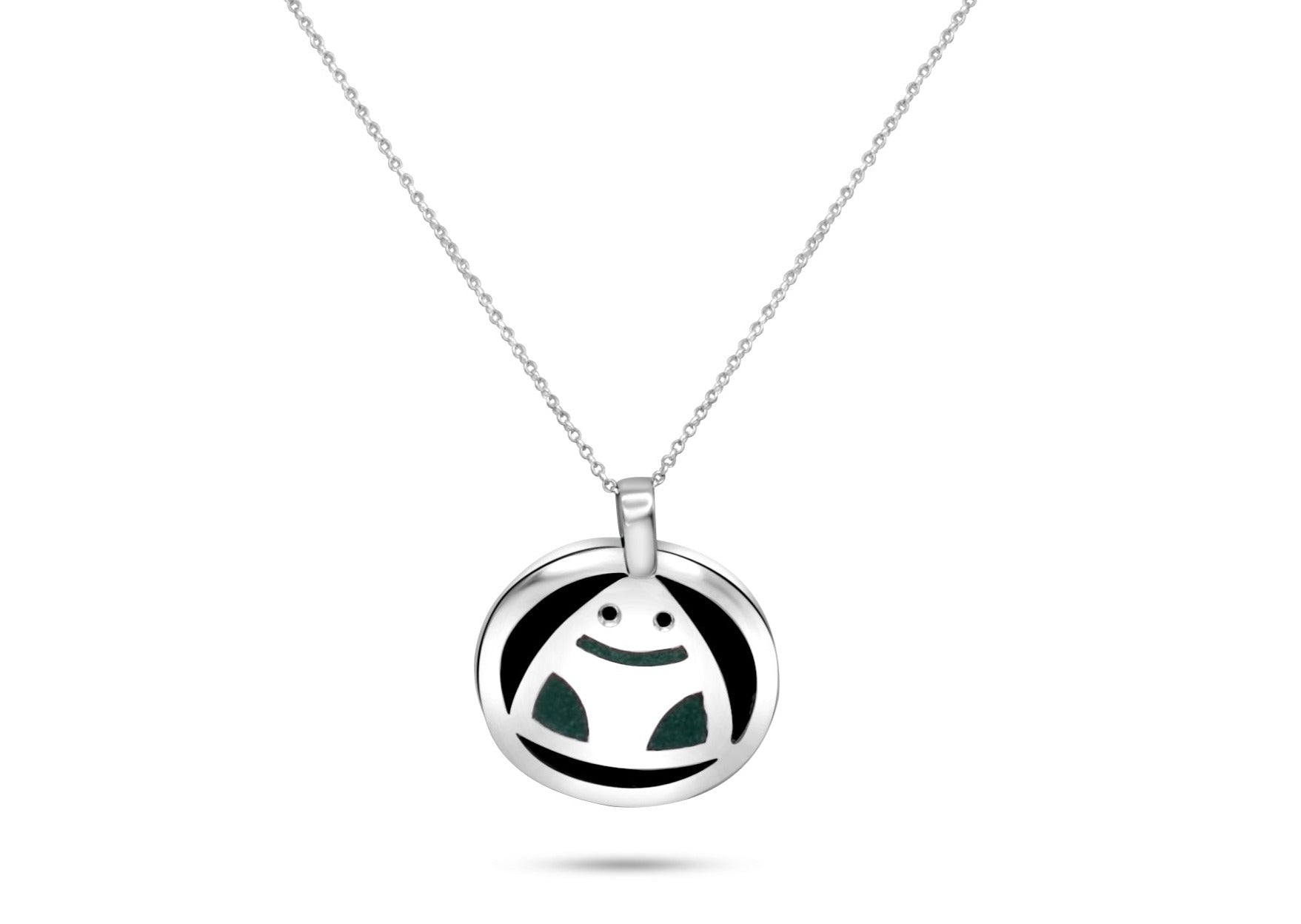 This image features a .925 sterling silver pendant necklace with a round Muiraquitã frog design, incorporating a green malachite inlay and coconut shell, reflecting Amazonian culture.