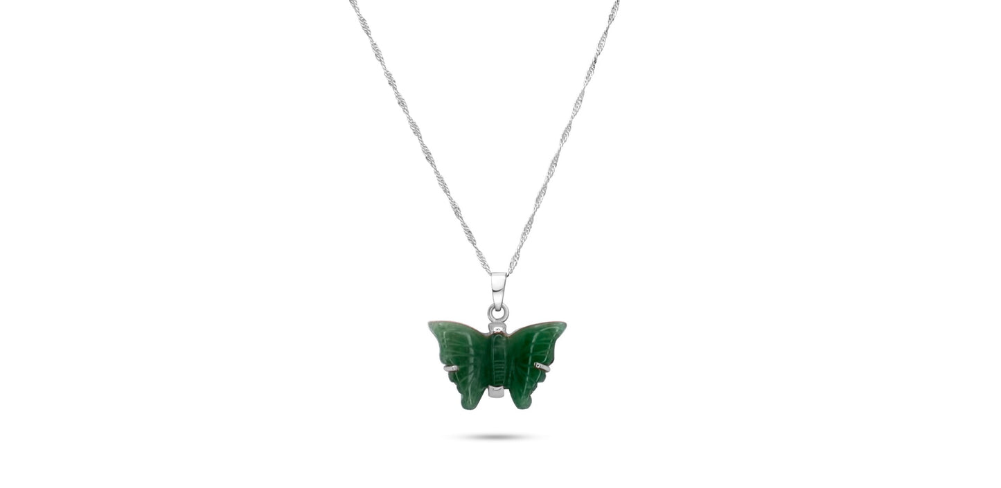 A handmade .925 sterling silver necklace with a pendant carved from green quartz into a delicate butterfly shape, symbolizing transformation.