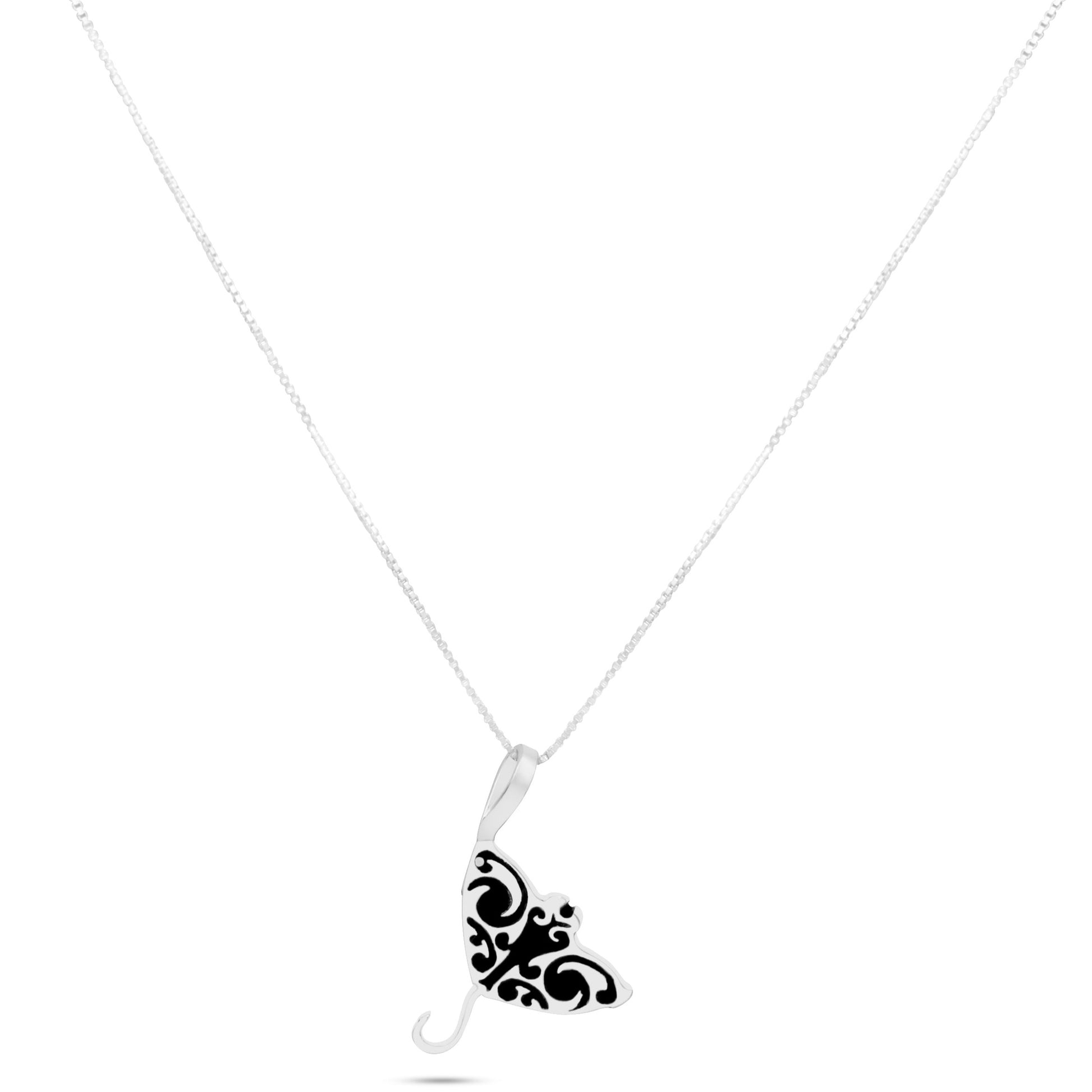 Sterling silver manta ray necklace. The manta ray pendant has a polished, shiny finish and features a realistic design with intricate details.