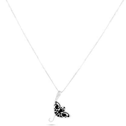 This necklace features a .925 sterling silver pendant shaped like a manta ray with a black inlay, made using an eco-friendly local technique blending recycled mineral powder and resin.