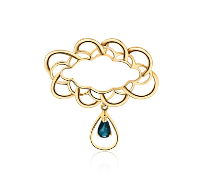 The pendant features a symmetrical, cloud-like design with interlocking, rounded shapes creating an openwork pattern in a warm gold tone, suggesting it is crafted from 18-karat gold. 