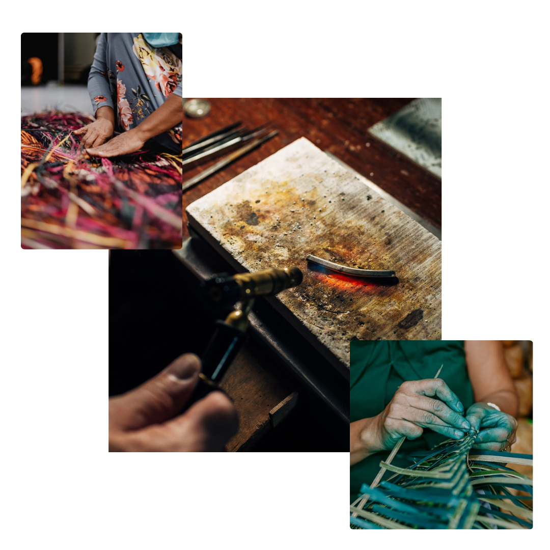 A close-up image of a jewelry-making process, featuring a blowtorch heating a curved piece of metal on a stained metal block, with jewelry-making tools blurred in the background. The heat's gradient colors on the metal piece suggest the careful handcrafting involved in the art of jewelry fabrication.