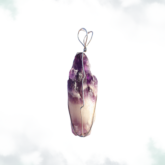 A raw Brazilian amethyst crystal with deep purple hues and natural gradients, wrapped in a simple silver wire with a heart-shaped loop.