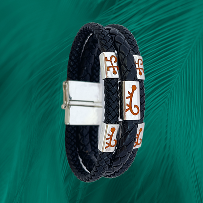 The bracelet showcases a vegan leather braid with .925 silver charms, featuring a Marajoara monkey motif.