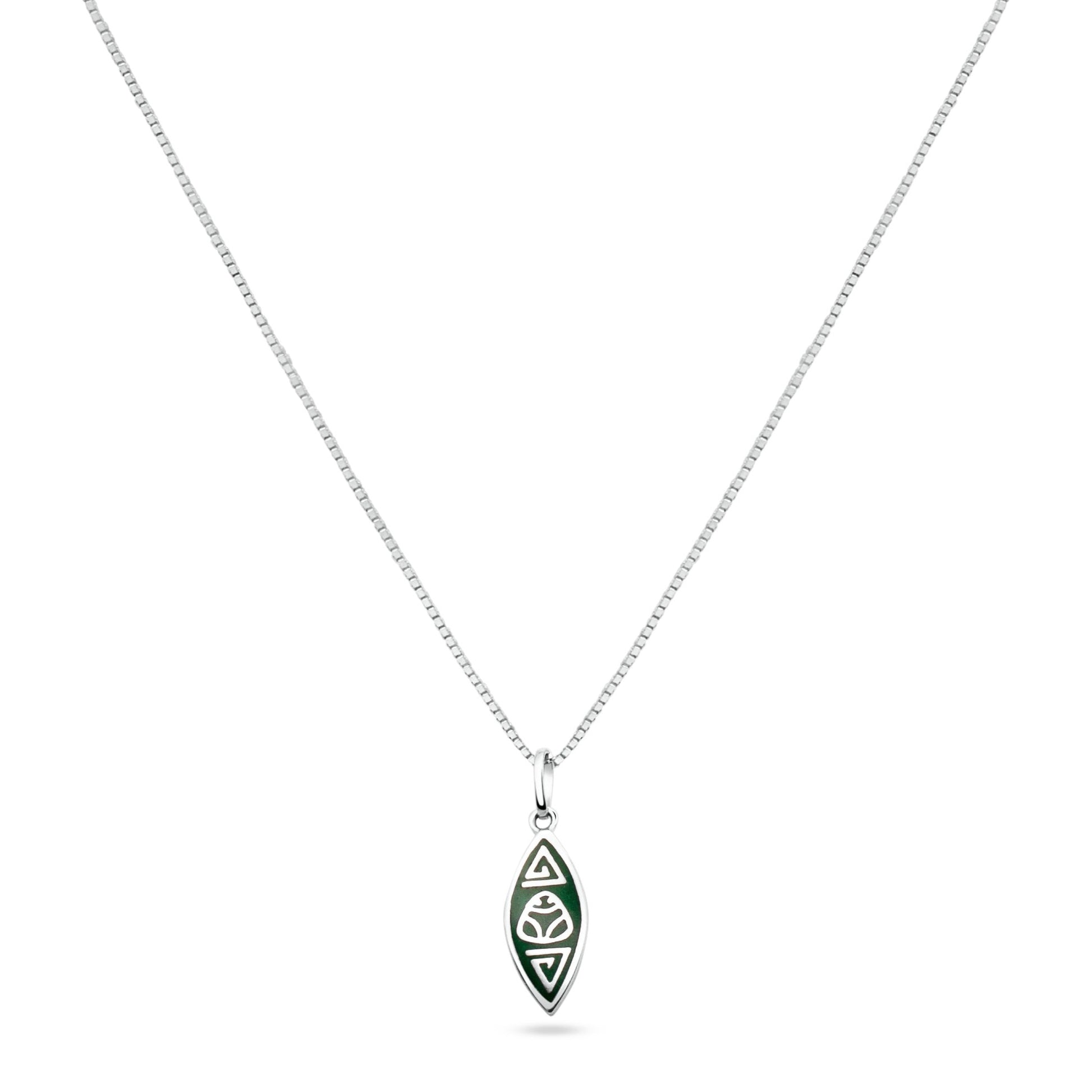 A silver necklace with a canoe-shaped pendant from the Marajoara Collection, featuring a central muiraquitã symbol, held sacred by Amazonian indigenous cultures, accented by triangular forms at each end