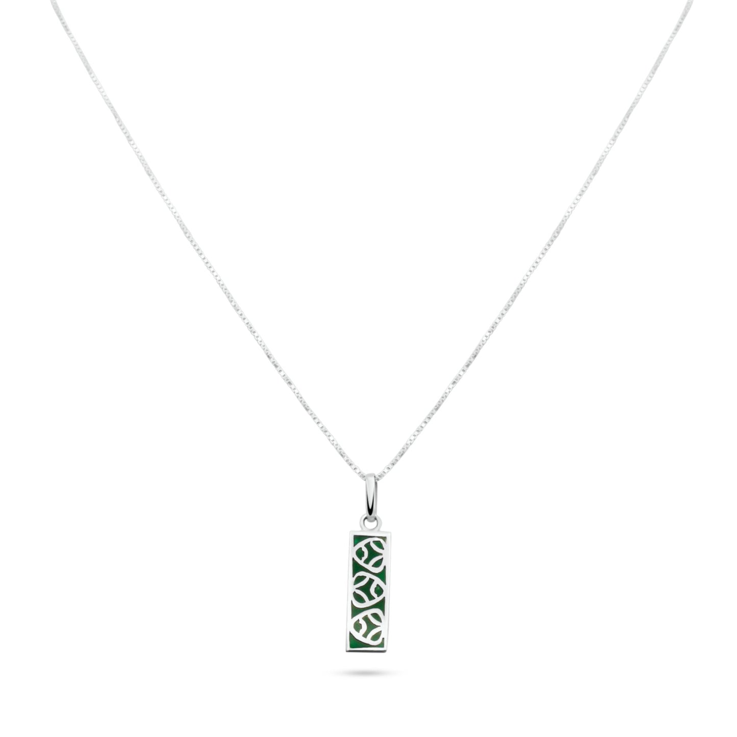 A silver necklace with a green malachite-inlaid pendant inspired by the muiraquitã of Amazonian lore, believed to bestow luck and joy.