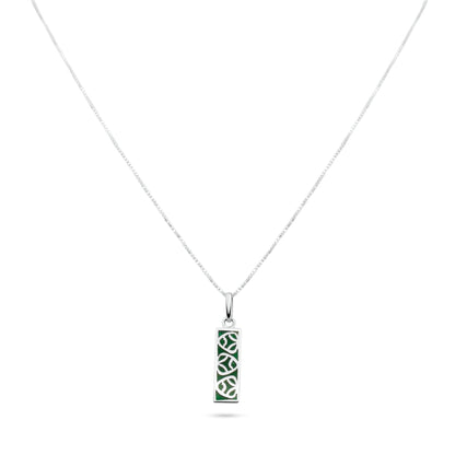 A silver necklace with a green malachite-inlaid pendant inspired by the muiraquitã of Amazonian lore, believed to bestow luck and joy.