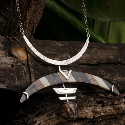 Bow & Arrow necklace, showcases sustainable design featuring seed pods, bone, and quartz.