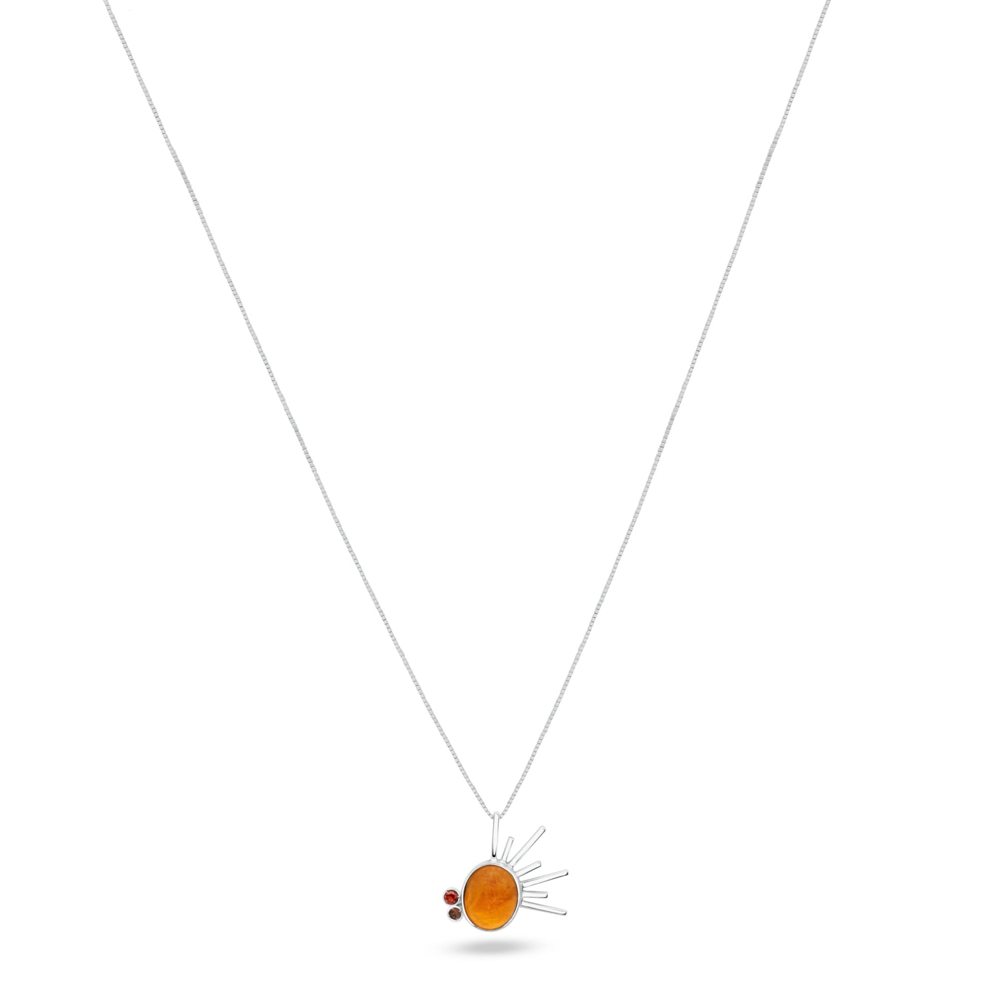 Sterling silver necklace with a radiant sun-inspired pendant, centered with a golden tucupi gemstone, flanked by garnet and smoky quartz, on a white backdrop.