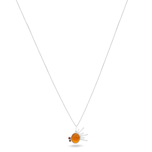 Sterling silver necklace with a radiant sun-inspired pendant, centered with a golden tucupi gemstone, flanked by garnet and smoky quartz, on a white backdrop.